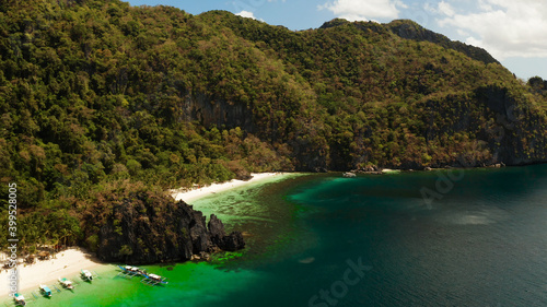 Tropical beach and clear blue water. El nido  Philippines  Palawan. Seascape with tropical rocky islands  ocean blue water. Summer and travel vacation concept