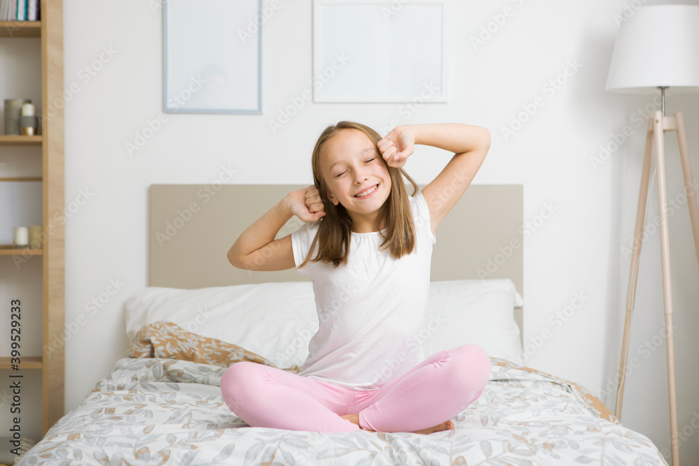 Little girl in good mood in pajamas in the bedroom Little girl in good mood in pajamas in the bedroom