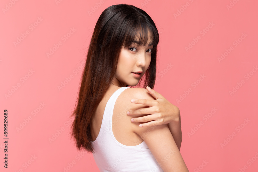 Young Beautiful Asian woman smile touching shoulder with clean and fresh skin Happiness and cheerful with positive emotional,isolated on pink background,Beauty Cosmetics and spa Treatment Concept Young Beautiful Asian woman smile touching shoulder with clean and fresh skin Happiness and cheerful with positive emotional,isolated on pink background,Beauty Cosmetics and spa Treatment Concept