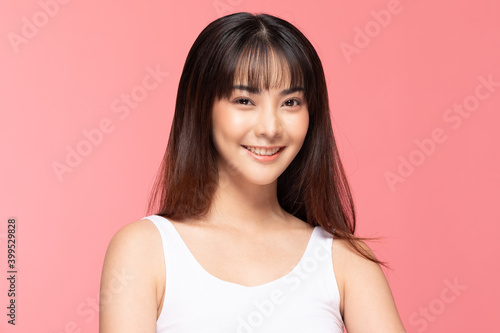 Beautiful Asian woman looking at camera smile with clean and fresh skin Happiness and cheerful with positive emotional,isolated on pink background,Beauty Cosmetics and spa Facial treatment Concept