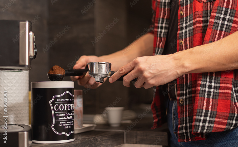 Man making espresso at his coffee station at home.