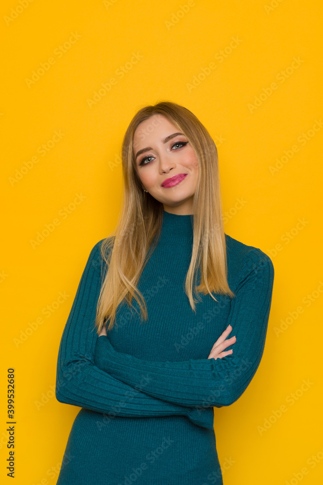 Fototapeta premium Portrait Of Smiling Young Woman In Teal Sweater