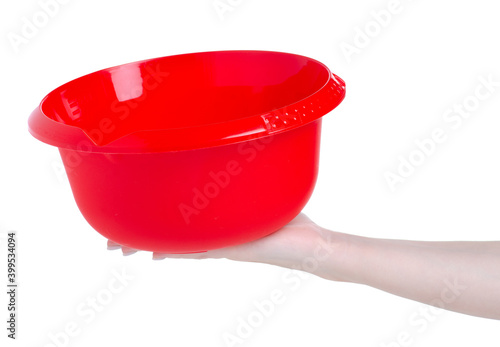 Red plastic bowl in hand on white background isolation