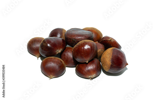 A pile of fresh chestnuts isolated on the white background. Close-up and macro. Focus stacking.