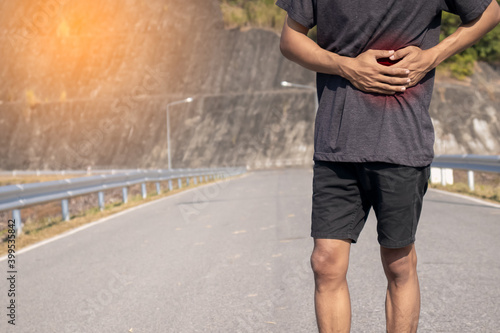 Men hurt their stomach during jogging training.