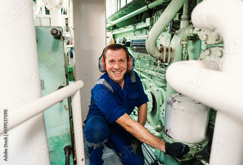 Photography Marine engineer officer controlling vessel engines and propulsion in engine control room ECR