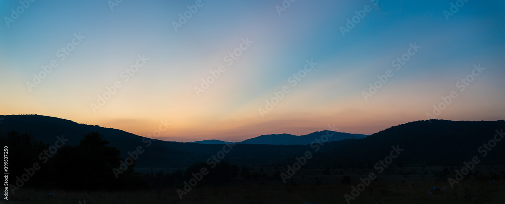Panoramic image of amazing sunset behind a mountain, Croatia.