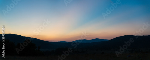 Panoramic image of amazing sunset behind a mountain  Croatia.