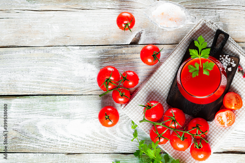 Glass of fresh tomato juice on the wooden background, free space for your text Glass of fresh tomato juice on the wooden background, free space for your text