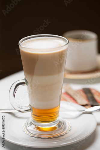 Latte in tall glass and desserts