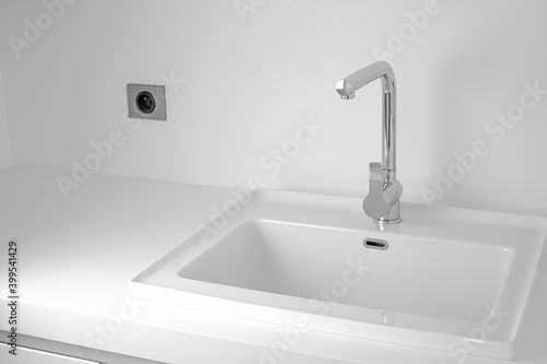 Modern bathroom interior with sink and chrome faucet.