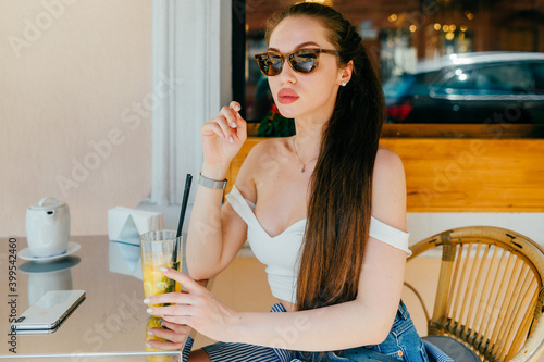 Young glamour sexy woman posing with juice photo