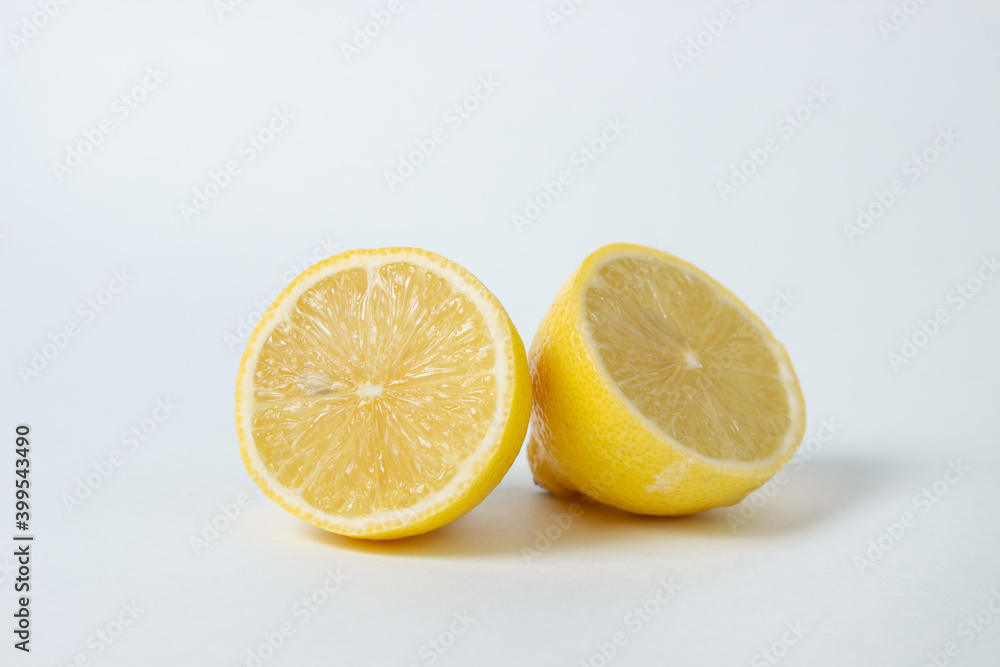 Lemons on a white background. Citrus fruit. Healthy food. Sliced lemon. Sour fruit Lemons on a white background. Citrus fruit. Healthy food. Sliced lemon. Sour fruit