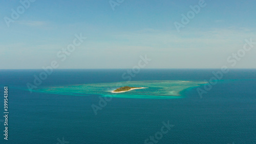 Tropical island Canimeran with sandy beach in the blue sea with coral reef, top view. Summer and travel vacation concept. Balabac, Palawan, Philippines.