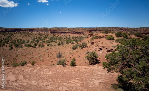 Amazing sandstone monoliths in a barren desert prairie on a blue partly cloudy summer day at Capitol Reef National Park in Torrey Utah photo