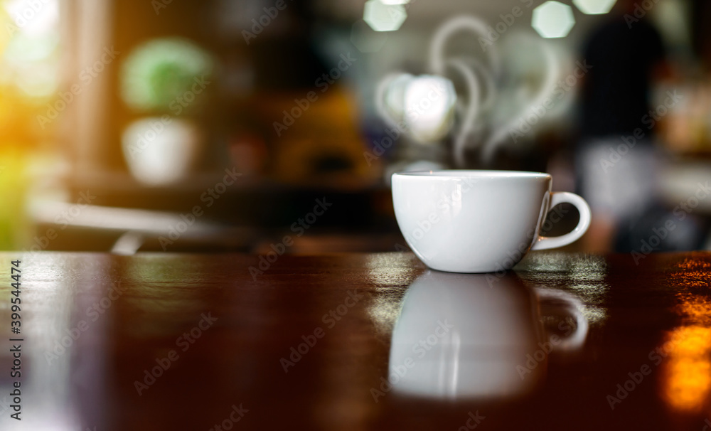Hot Coffee Cup on Wood Table in blurred Coffee Shop background. Hot Coffee Cup on Wood Table in blurred Coffee Shop background.