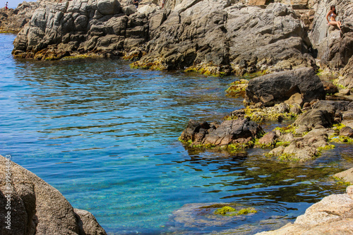 Spain mediterranean sea. A cove surrounded by stones.