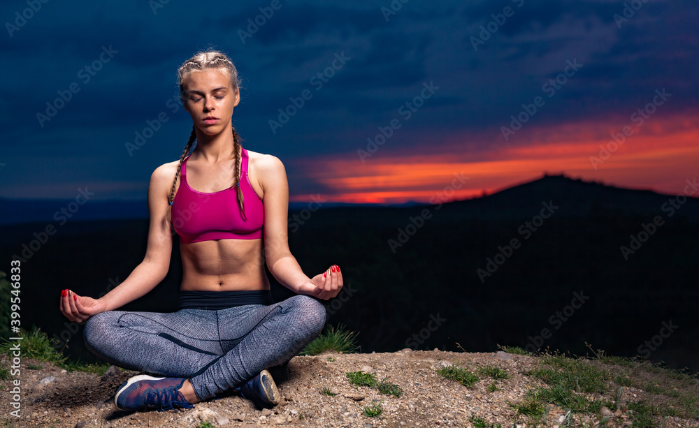 Determined Athletic Fitness Woman Meditating on Hills at Sunset