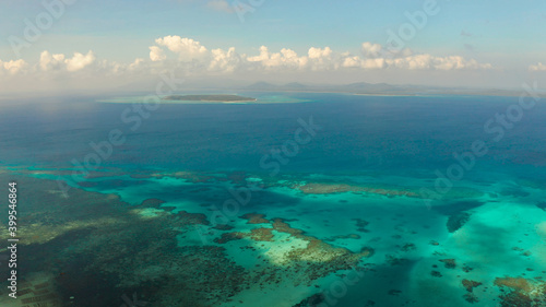 Tropical lagoons with turquoise water, coral reef and tropical islands in the blue sea, top view. Balabac, Palawan, Philippines. Summer and travel vacation concept.