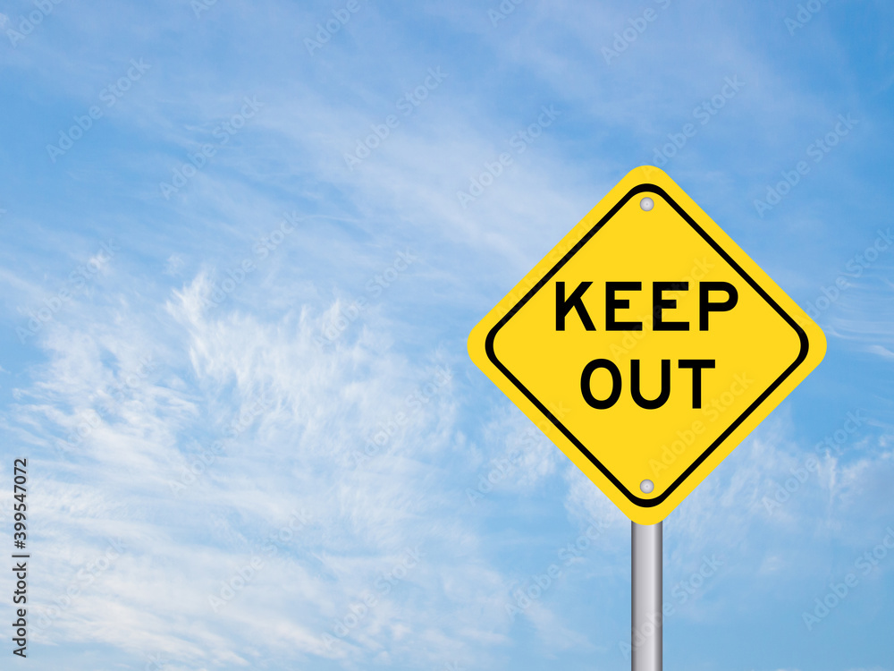 Yellow transportation sign with word keep out on blue sky background