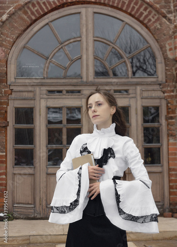 Russia, Moscow - 22/11/2020: Photo session in the style of a girl student of the 19th century. Beautiful tender girl.