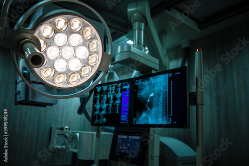 Surgery lamp and x-ray medical scan computer machine show x-ray images on monitor in operating room