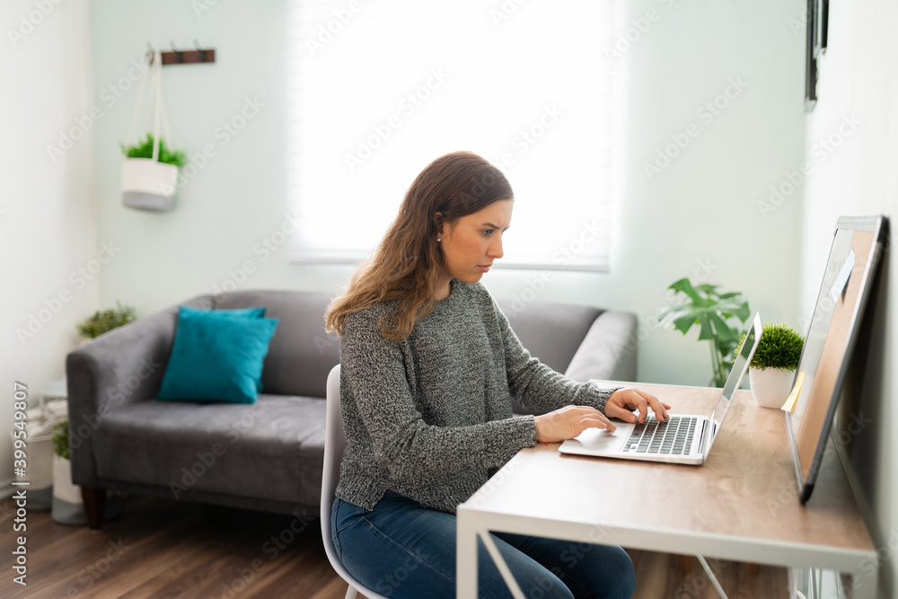 Young woman doing home office on her laptop Young woman doing home office on her laptop