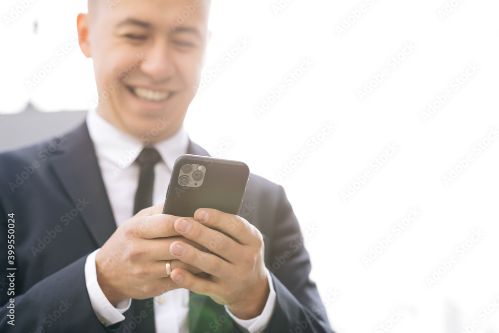 Stylish Businessman Exiting from the Modern Office. Using his Smartphone. Sliding on Mobiles Screen. Looking Successful, Confident on Summer Day Stylish Businessman Exiting from the Modern Office. Using his Smartphone. Sliding on Mobiles Screen. Looking Successful, Confident on Summer Day