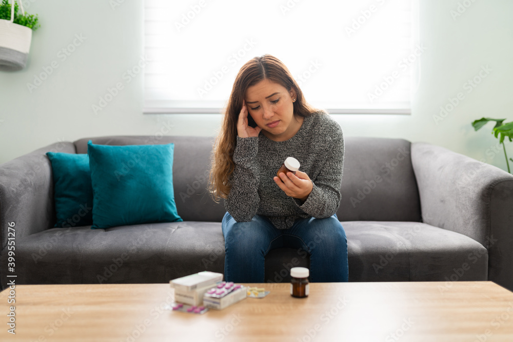 Attractive woman looking at a lot of prescribed pills Attractive woman looking at a lot of prescribed pills