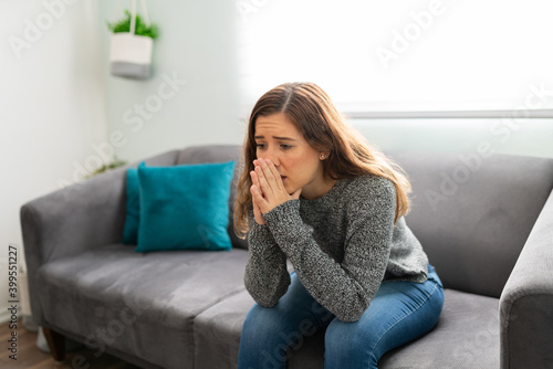 Woman sitting on the living room and stressed about her problems
