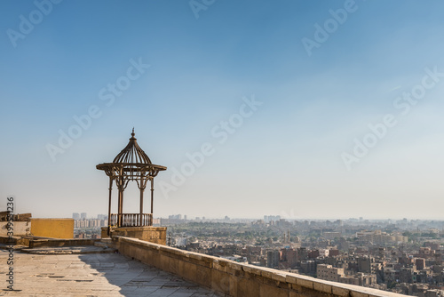 Pavilion of Saladin Citadel of Cairo and aerial view of Cairo of crowded buildings with dusty sky