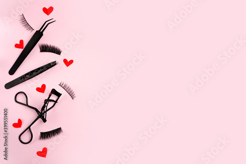 Fotografie, Tablou Lash curler, false lashes and tweezers for eye make-up on pink background with r