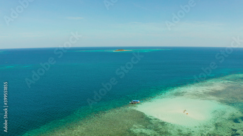 Sandy beach with tourists on a coral atoll in turquoise water, from above. Summer and travel vacation concept. Balabac, Palawan, Philippines. © Alex Traveler
