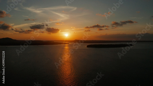 Colorful sunset over tropical islands, aerial view. Sunset over ocean. Balabac, Palawan, Philippines