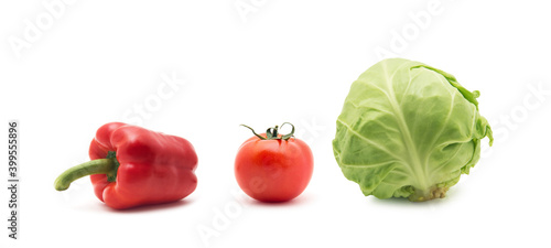 whole green cabbage, tomato and sweet pepper isolated on white
