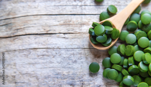 There are many spirulina and chlorella tablets. Selective focus. photo