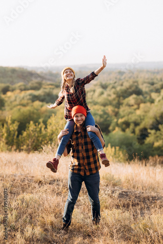 Cheerful guy and girl on a walk in bright knitted hats