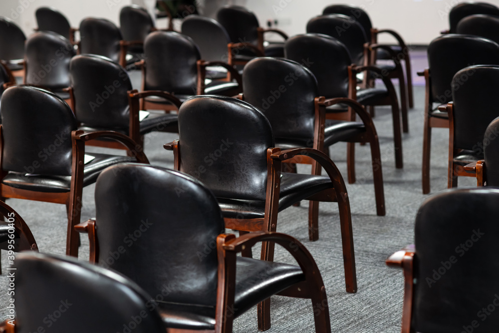 Obraz premium Empty black chairs stand in conference hall