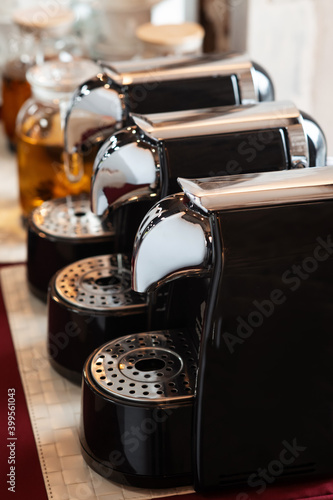 Capsule coffee machines stand in a row on the banquet table. Сatering