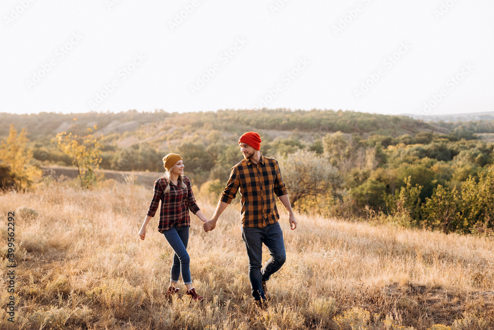 Cheerful guy and girl on a walk in bright knitted hats Cheerful guy and girl on a walk in bright knitted hats