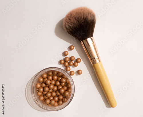 Makeup balls and a brush on a white background.