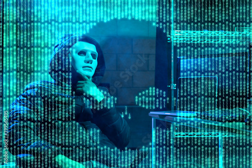 Hacker using laptop with binary code