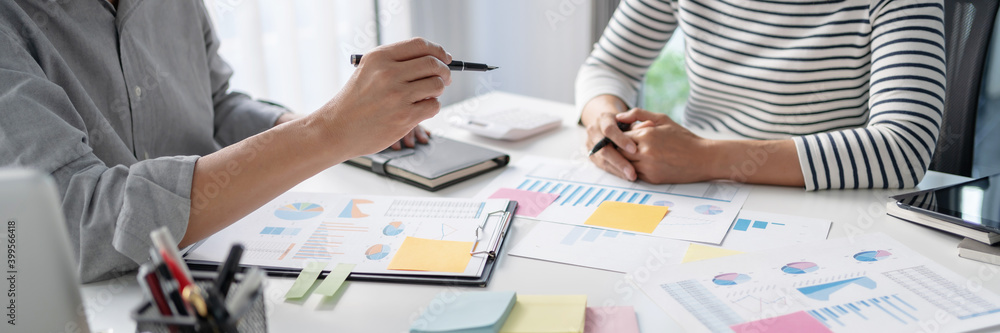 Business Startup team discussing on data report documents at modern workplace..