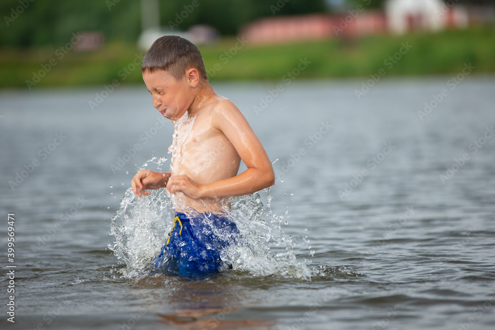 A little boy runs into a cold river. The child swims in the lake in summer. A little boy runs into a cold river. The child swims in the lake in summer.