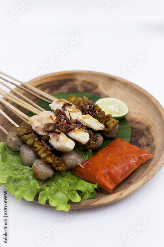 Chicken Satay or Sate Ayam - Indonesian famous food. Is a dish of seasoned, skewered and grilled meat, served with a peanut sauce. Isolated White background