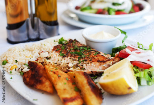 Greece food - Grilled salmon and vegetables on white plate