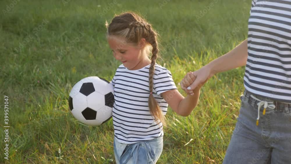happy family children with mom walk play soccer ball in the park. kid dream concept. kid play ball on green fun grass in park. happy family mom with children walks playing in the park on the grass happy family children with mom walk play soccer ball in the park. kid dream concept. kid play ball on green fun grass in park. happy family mom with children walks playing in the park on the grass