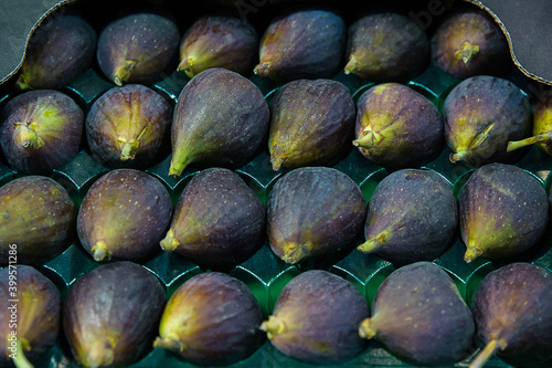 Black Mission figs or Franciscana figs, high quality variety of the common fig or Ficus carica in a plastic tray at the supermarket or grocery store, Mediterranean fruit with multiple health benefits