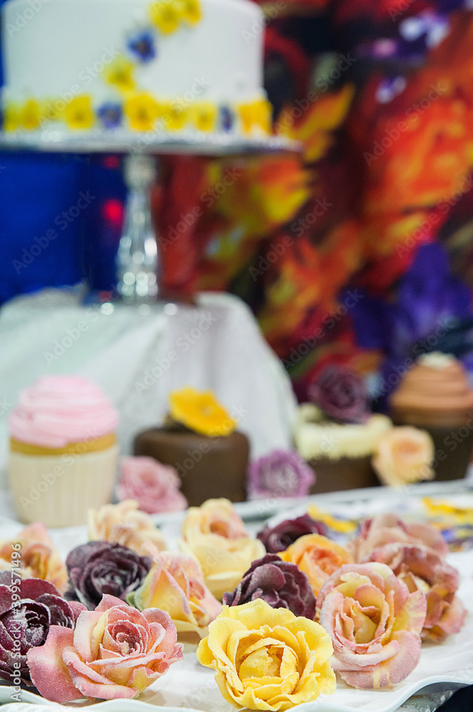 Display of edible crystalized flowers, high end deserts decoration and delicacy used to embellish formal wedding cakes or cupcakes, delicate natural candied roses created for an unique taste sensation
