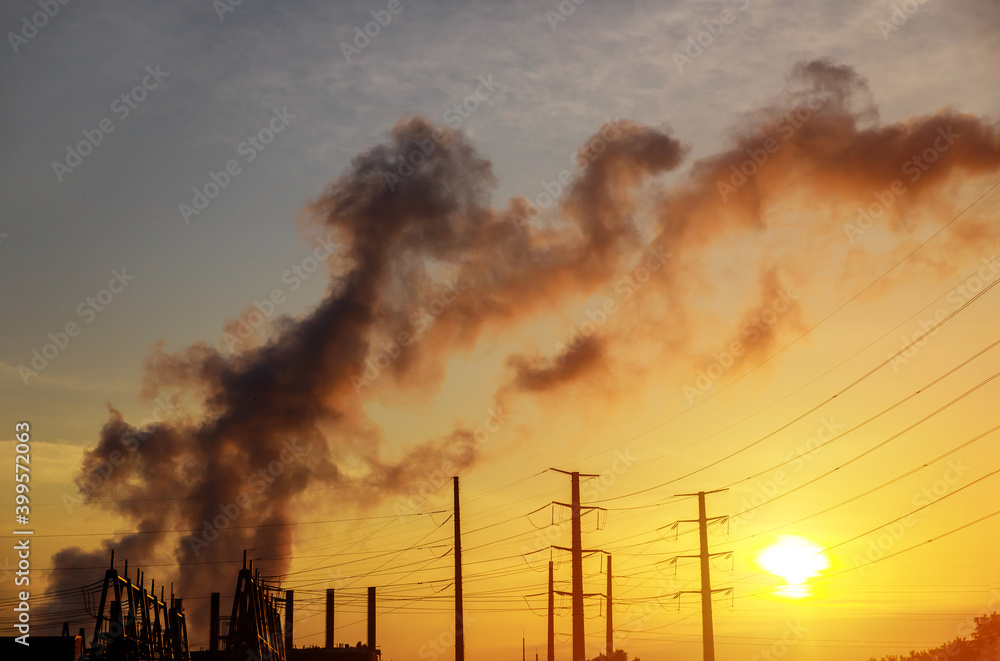 Factory pipe polluting air at dusk, the thermal power plants with during sunrise
